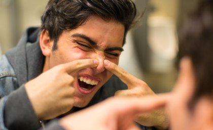 man popping a pimple