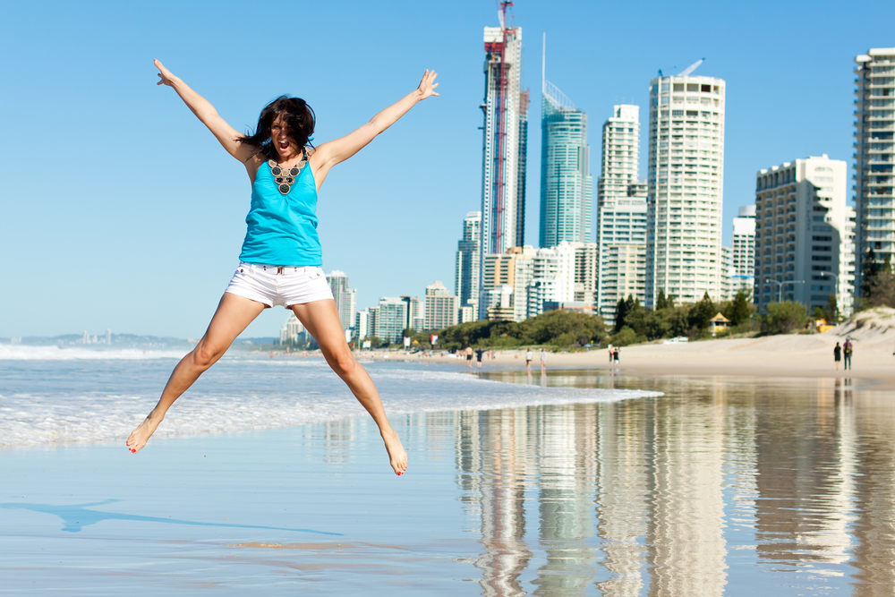 teenager jumping on a beach