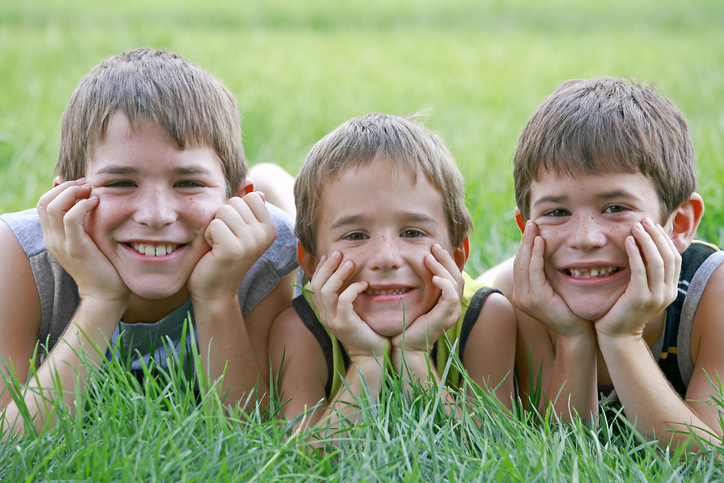 boys lying on grass