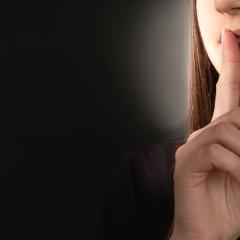 woman pressing lips to mouth 