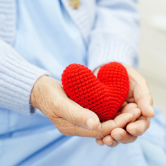 Patient holding crochet love heart