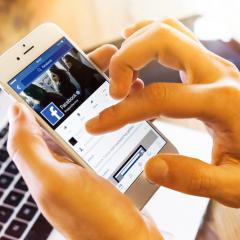 person using facebook on an iphone