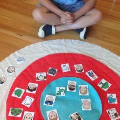 child sat on mat placing items in circle