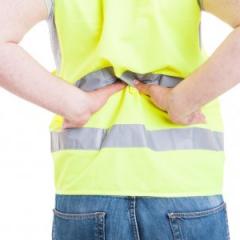 man holding his lower back