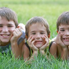 boys lying on grass