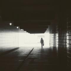 woman walking in tunnel